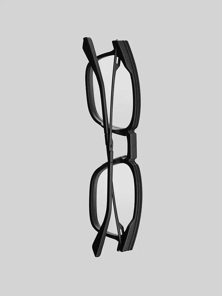 Folded side profile of the NIRVAN JAVAN ZURICH frame, highlighting SLS 3D printed eyewear geometry and screwless hinge engineering