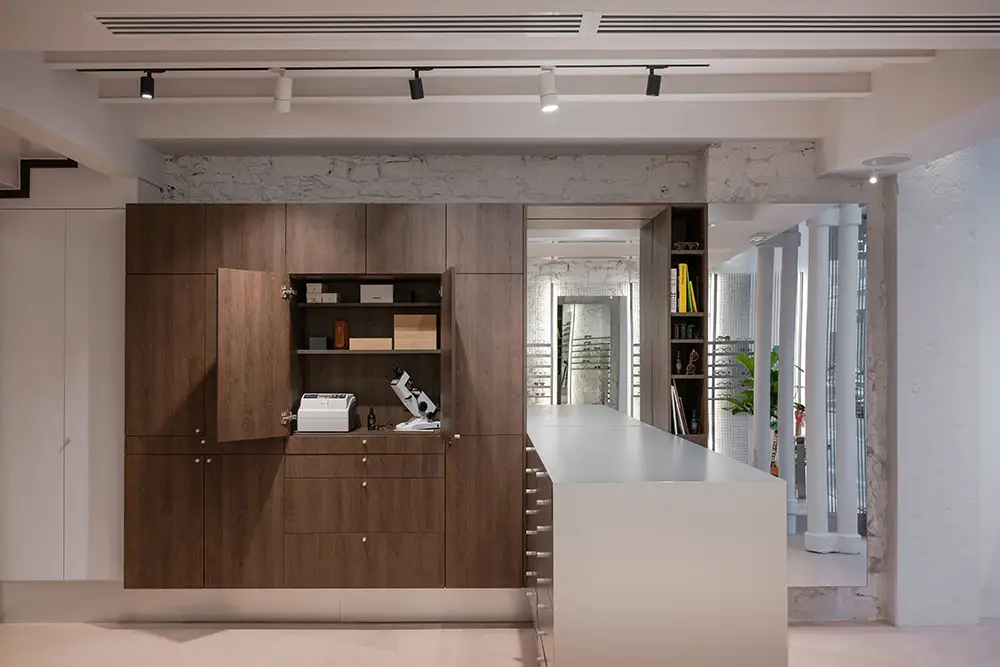Optometry equipment integrated into cabinetry at LOULOU new optical store Lyon