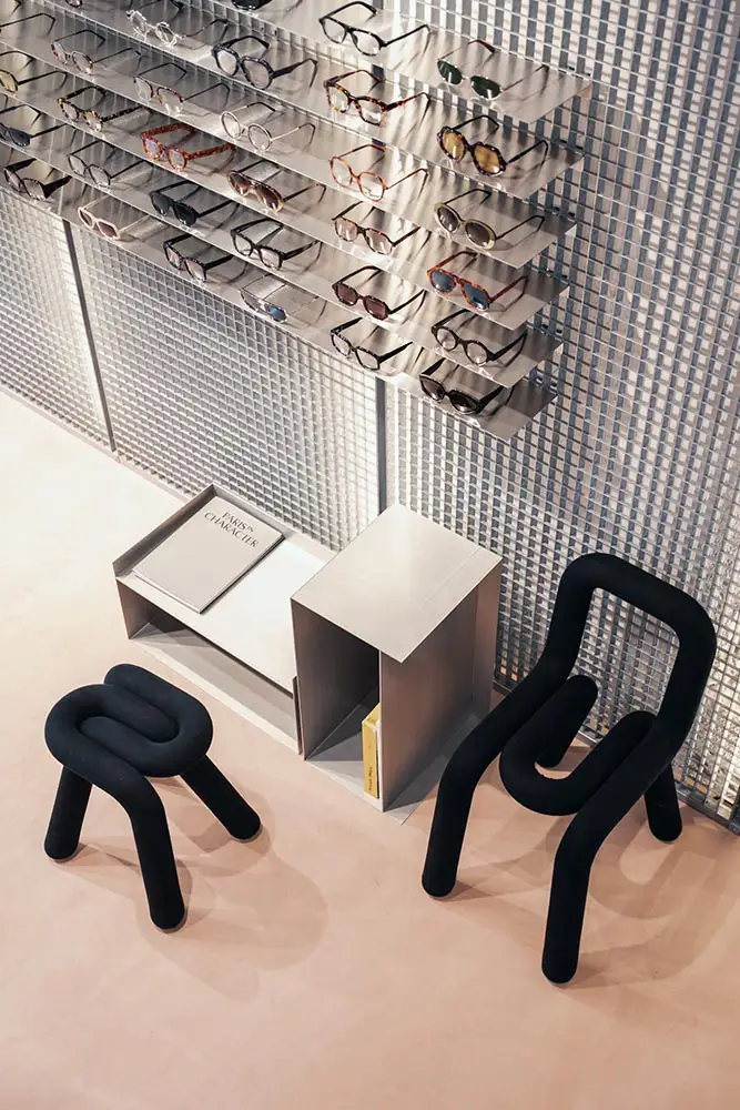 Independent eyewear display inside LOULOU new optical store Lyon with sculptural black chairs