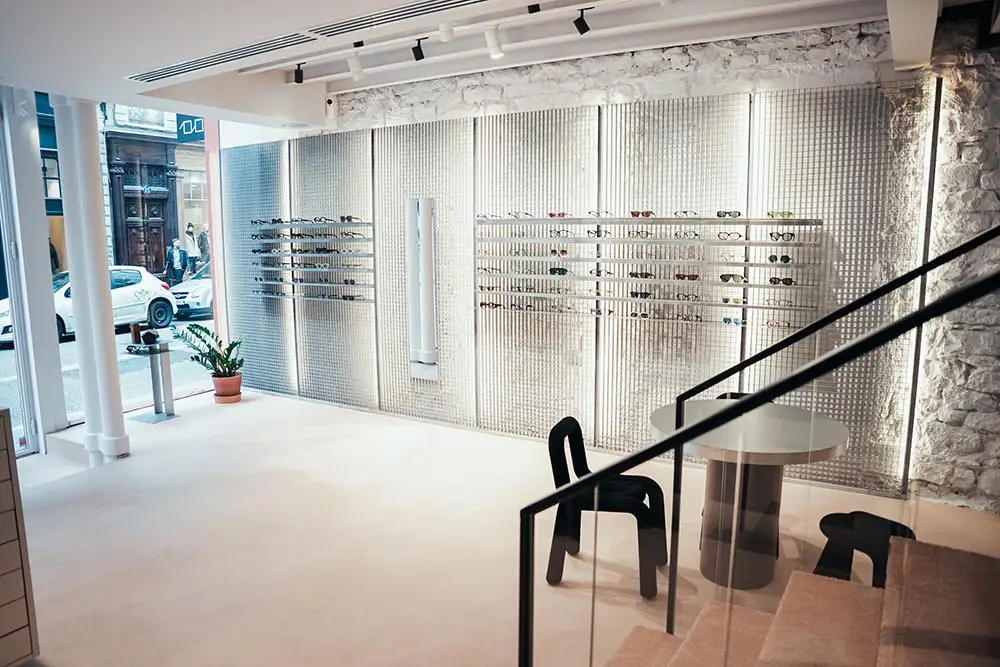Consultation table and eyewear displays at LOULOU new optical store Lyon
