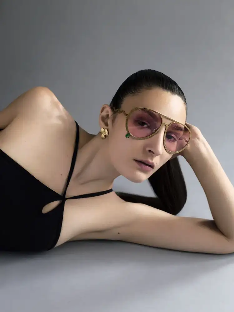 fine jewellery eyewear gold frame with pink lenses in luxury fashion portrait
