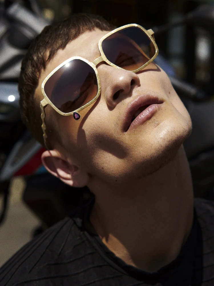 fine jewellery eyewear gold square frame worn outdoors in sunlight