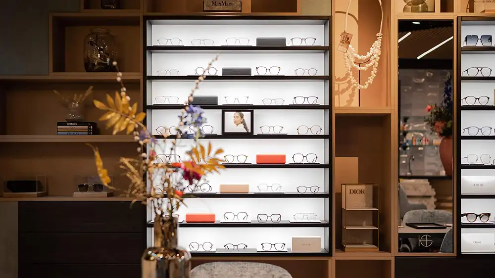 Carré eyewear displays integrated in optical store interior with precision lighting