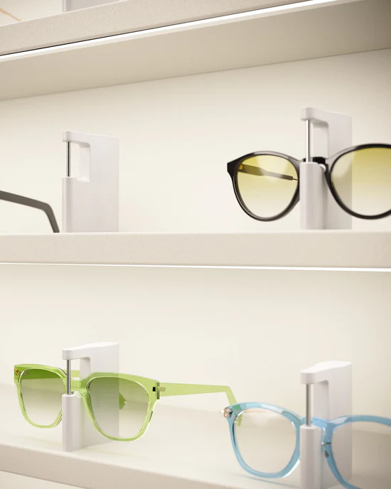 optical store display lighting detail highlighting eyewear frames on shelf